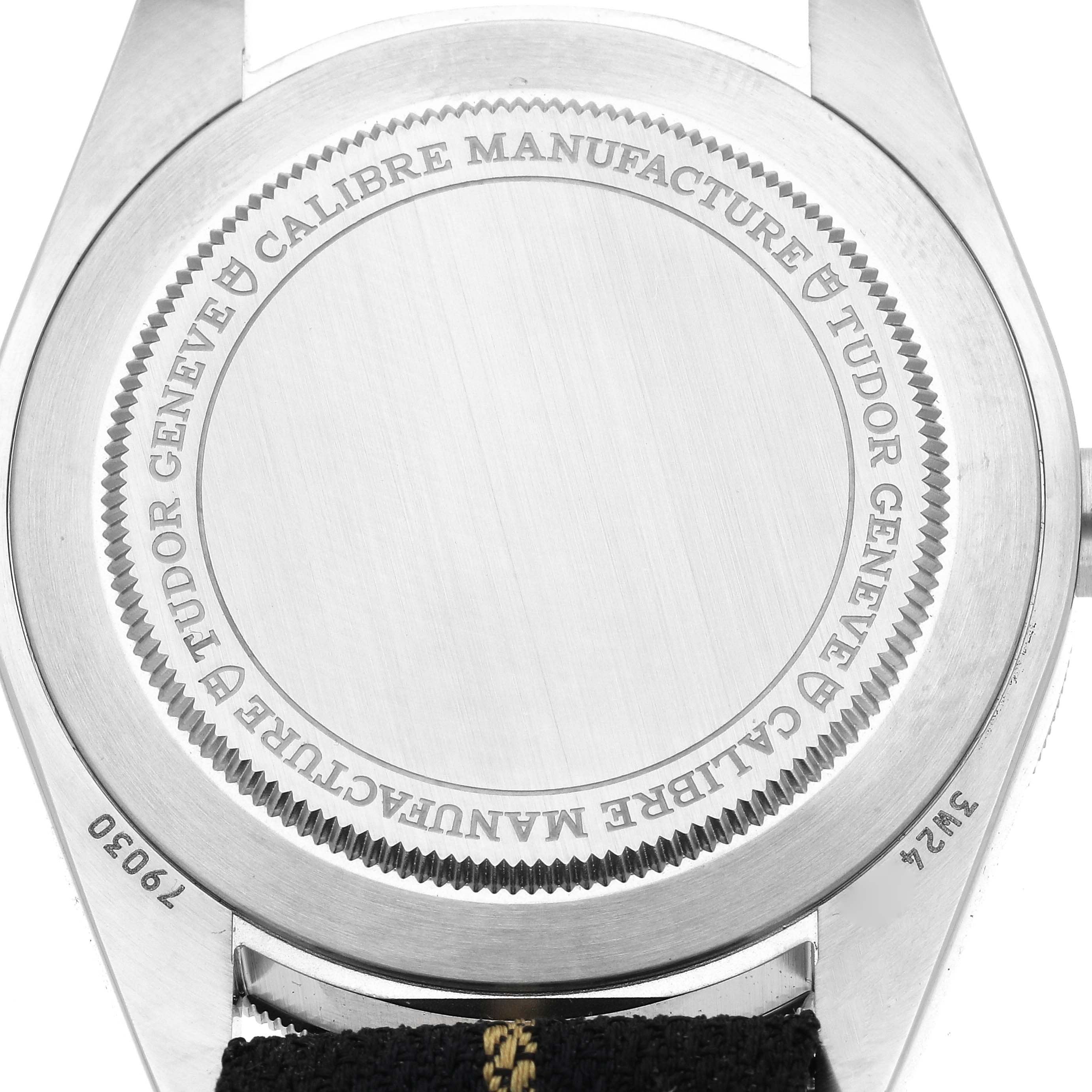The image shows the back casing of a Tudor Heritage Black Bay 79030 Men
s Stainless Steel Black Dial 79030 Men
s Stainless Steel Black Dial watch, highlighting the engraved details and serial number.