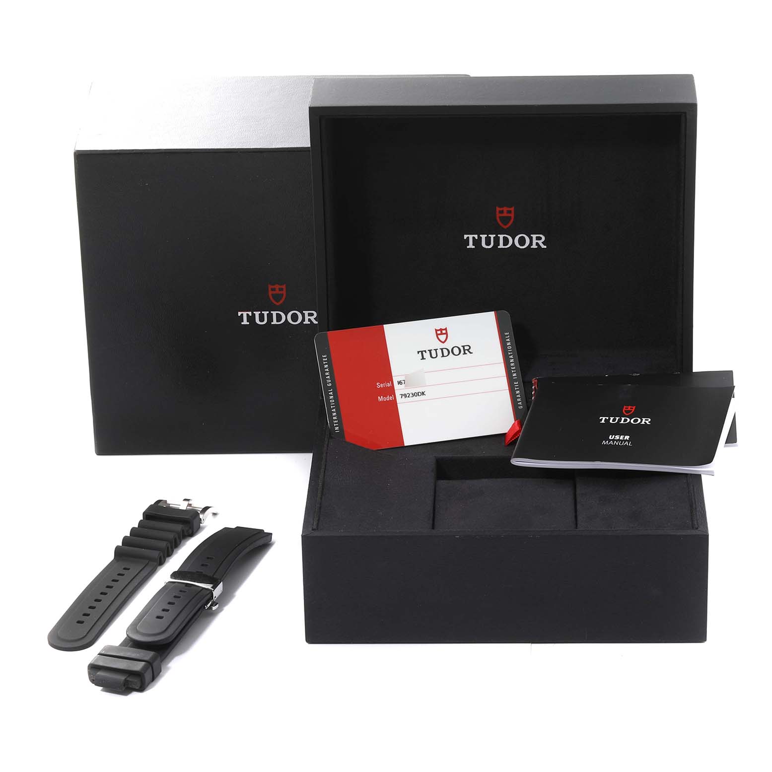 The image shows an open Tudor Heritage Black Bay 79230DK Men's Stainless Steel Black Dial 79230DK Men's Stainless Steel Black Dial watch box with additional straps, warranty card, and user manual.