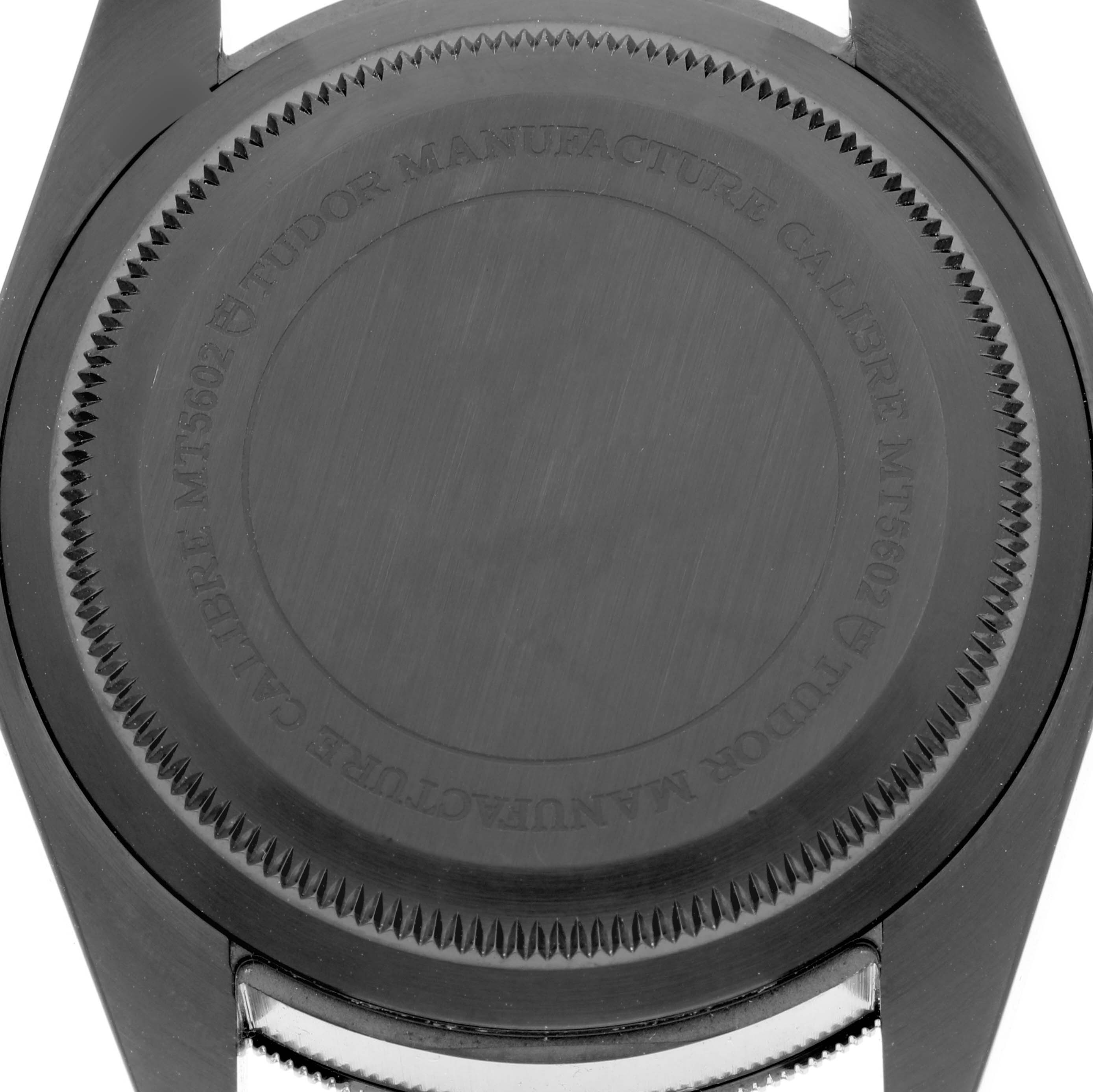 The image shows the case back of a Tudor Heritage Black Bay 79230DK Men's Stainless Steel Black Dial 79230DK Men's Stainless Steel Black Dial watch from a bottom view.