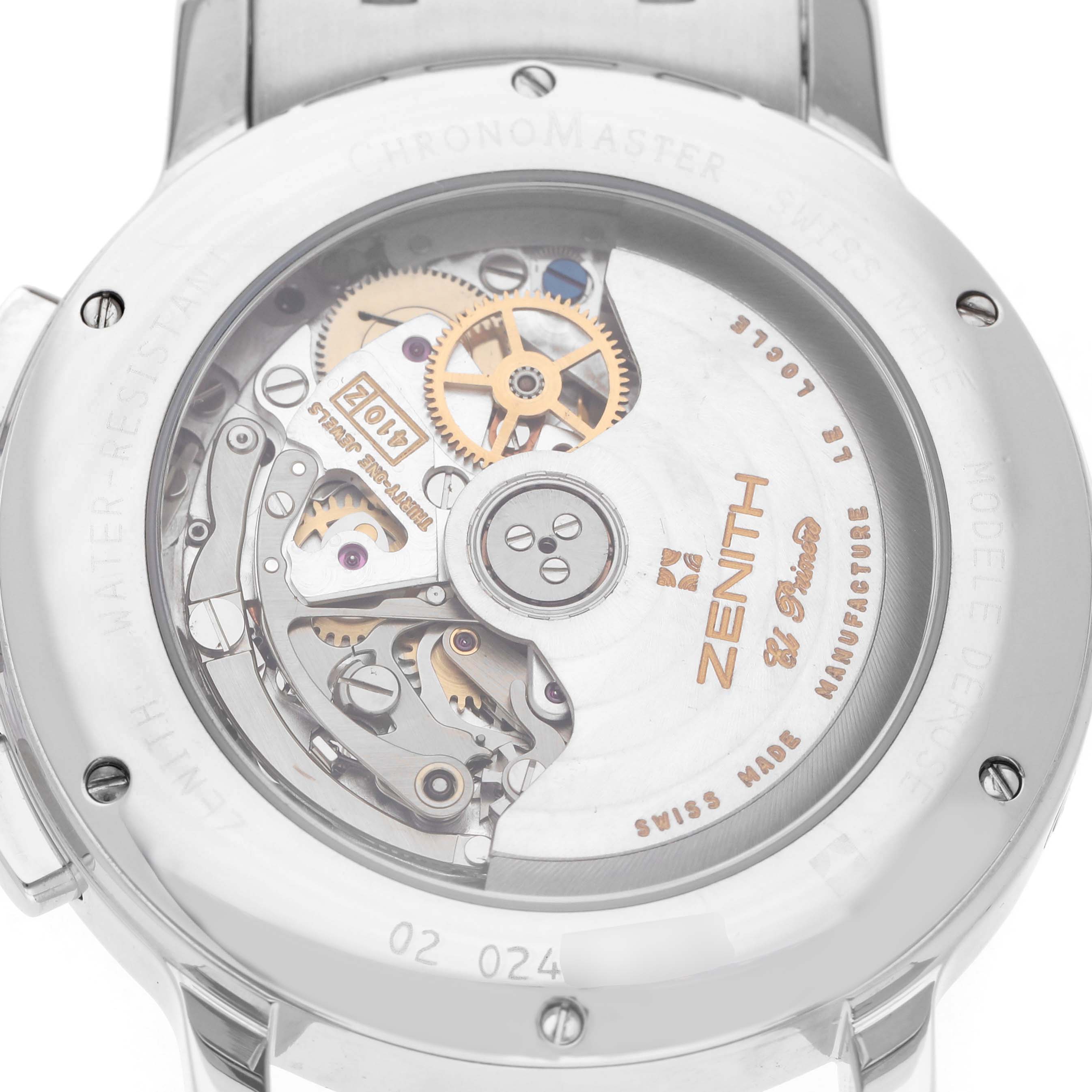 The image shows the case back of a Zenith El Primero 02.0240.410/21 Men's Stainless Steel Black Dial watch, highlighting its intricate movement and gears.