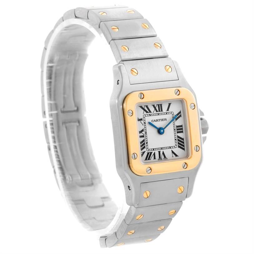 This image shows the face, bezel, and bracelet of a Santos de Cartier watch at a slight angle.