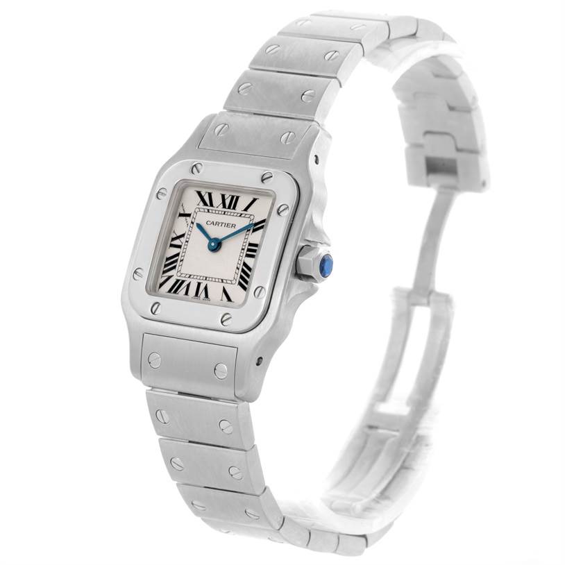 The image shows a Cartier Santos W20056D6 Women
s Stainless Steel Silver Dial W20056D6 Women
s Stainless Steel Silver Dial watch, highlighting its face, bezel, crown, and part of its bracelet at a slight side angle.