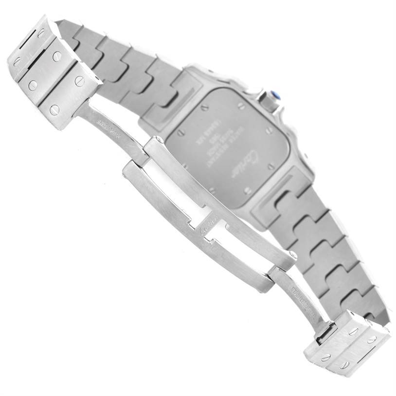 The image shows the underside and clasp mechanism of a Cartier Santos W20056D6 Women
s Stainless Steel Silver Dial W20056D6 Women
s Stainless Steel Silver Dial watch, including the case back and part of the metal strap.