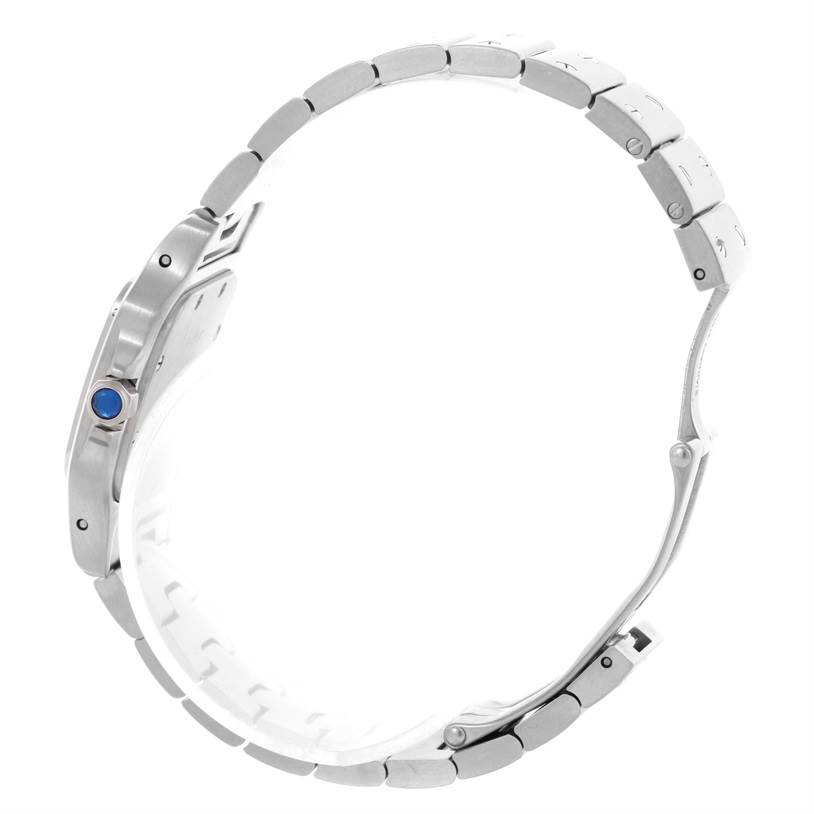 The image shows a Cartier Santos W20056D6 Women
s Stainless Steel Silver Dial W20056D6 Women
s Stainless Steel Silver Dial watch, highlighting its side profile and metal bracelet band with a prominent blue crown.