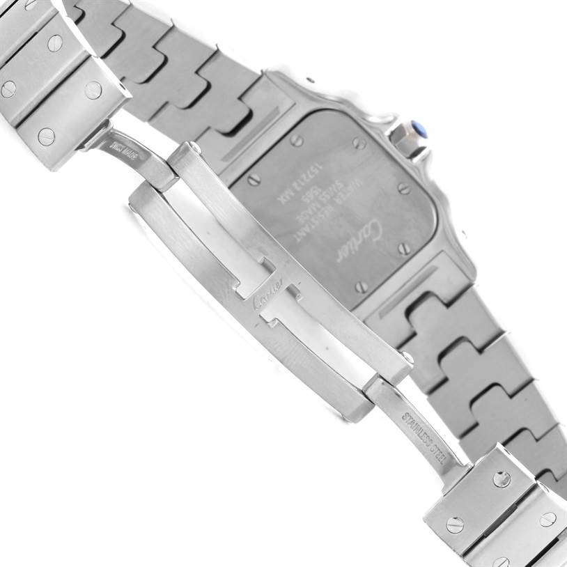 The image shows the back view of a Santos model watch by Cartier, focusing on the case back and part of the metal bracelet.