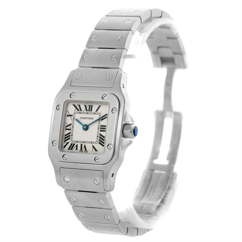 The image shows a close-up angled view of the Santos de Cartier watch, highlighting the face, bezel, bracelet, and crown.