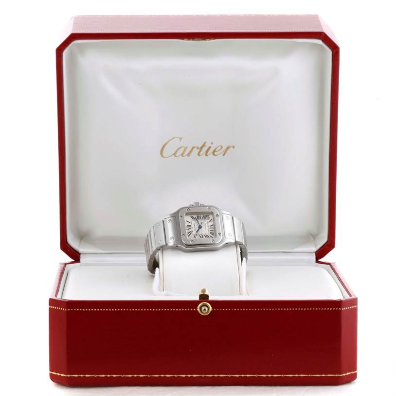 The Cartier Santos W20054D6 Women
s Stainless Steel Silver Dial W20054D6 Women
s Stainless Steel Silver Dial watch is displayed front-facing in an open red box with white interior.