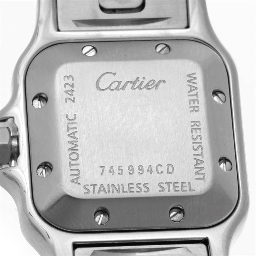 The image shows the back case of a Santos model by Cartier, displaying its branding and specifications.