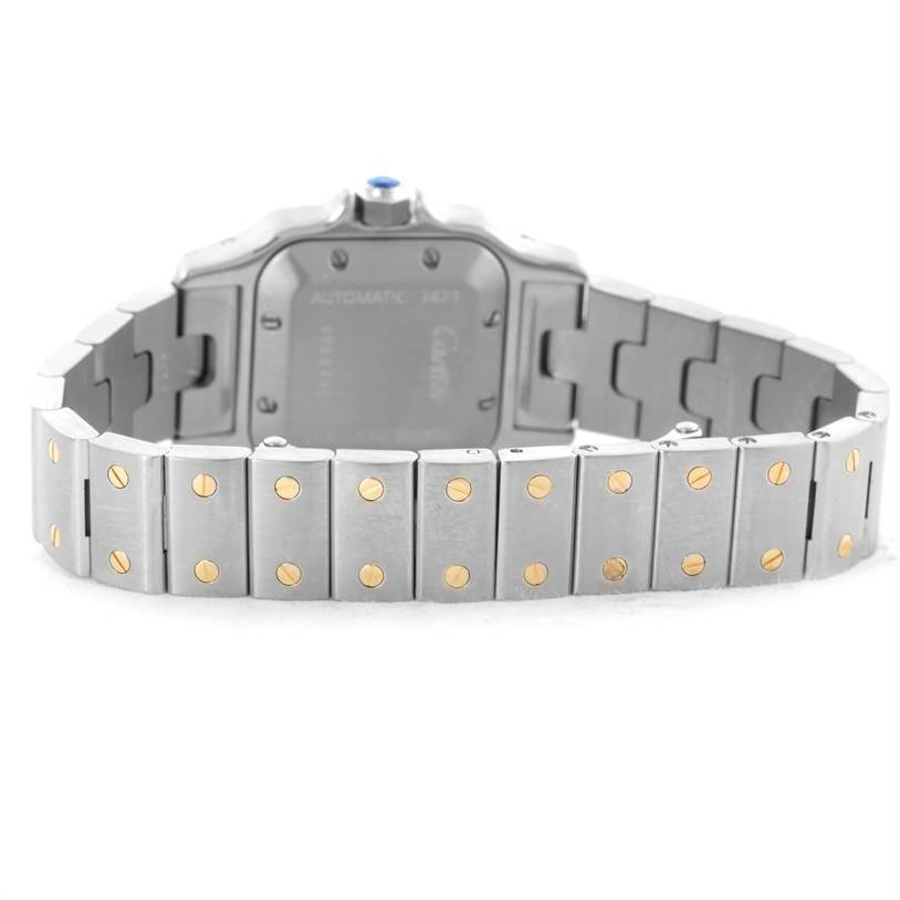 The image shows the back side of the Santos model by Cartier, highlighting its metal bracelet and clasp.