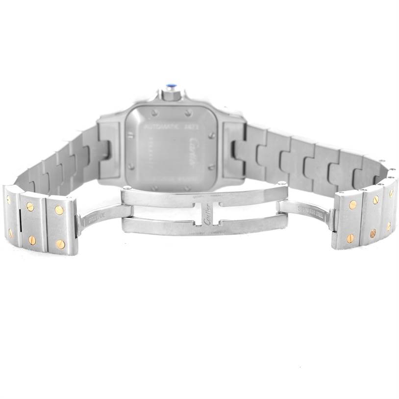 The image shows the back and clasp of a Santos model watch by Cartier, highlighting its metallic strap and deployment clasp.