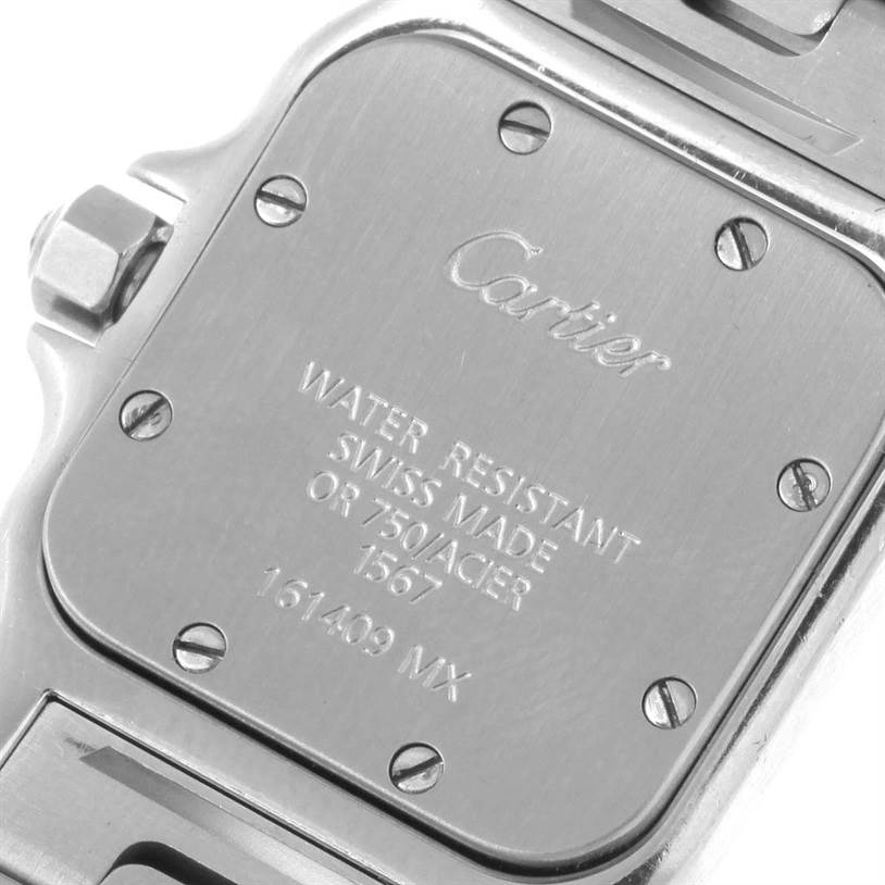 This image shows the case back of the Santos model by Cartier, featuring engravings and screws.