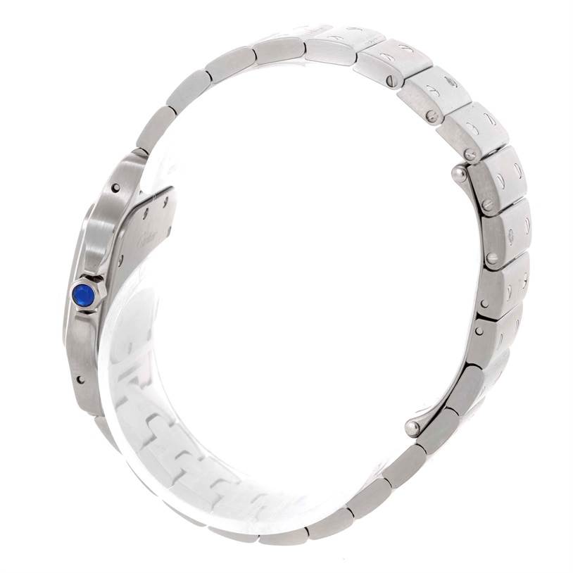 The image shows a side view of the Santos model by Cartier, highlighting the metal bracelet and crown with a blue gemstone.