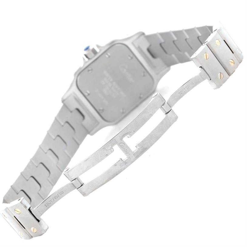 The image shows the underside of a Santos model by Cartier, highlighting the clasp and bracelet details.