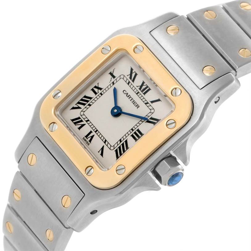 The Cartier Santos W20012C4 Women
s Stainless Steel Silver Dial W20012C4 Women
s Stainless Steel Silver Dial watch is shown from an angled top view, displaying the face, crown, and parts of the metal bracelet.