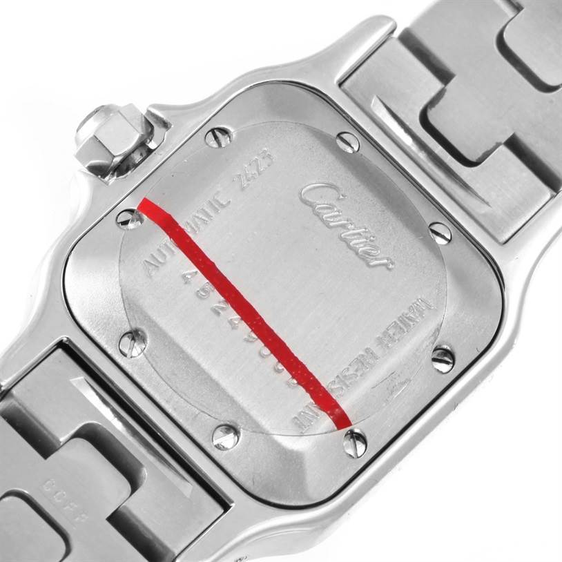 The image shows the back case and crown of a Cartier Santos W20057C4 Women
s Stainless Steel Silver Dial W20057C4 Women
s Stainless Steel Silver Dial watch, displaying the brand name and engravings.