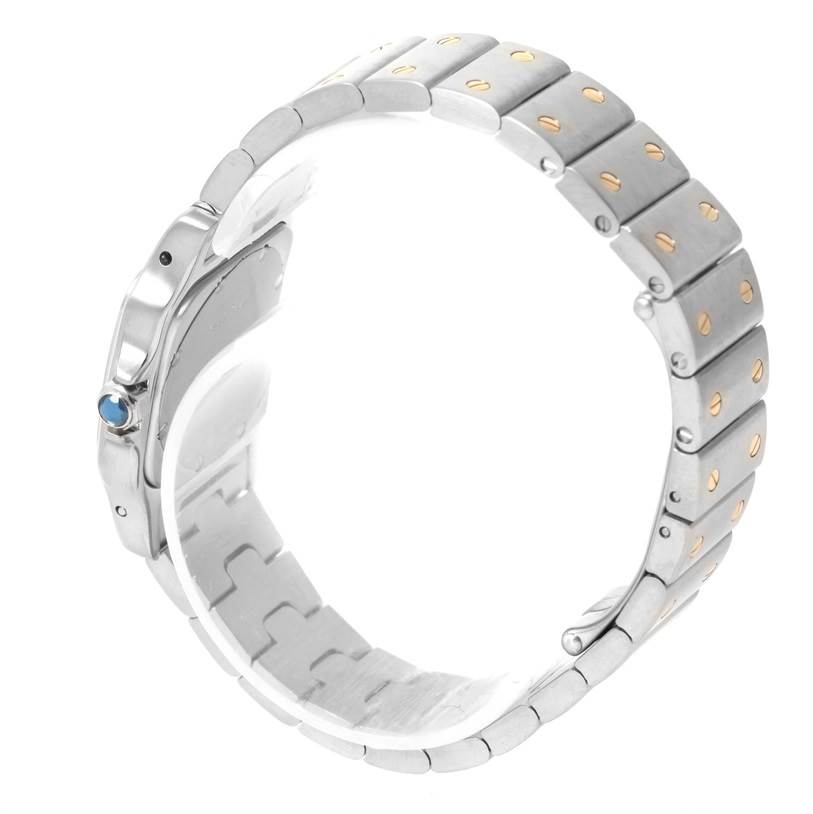 The image shows a side view of a Cartier Santos W20012C4 Women
s Stainless Steel Silver Dial W20012C4 Women
s Stainless Steel Silver Dial model watch, highlighting its metal bracelet and crown with a blue stone.