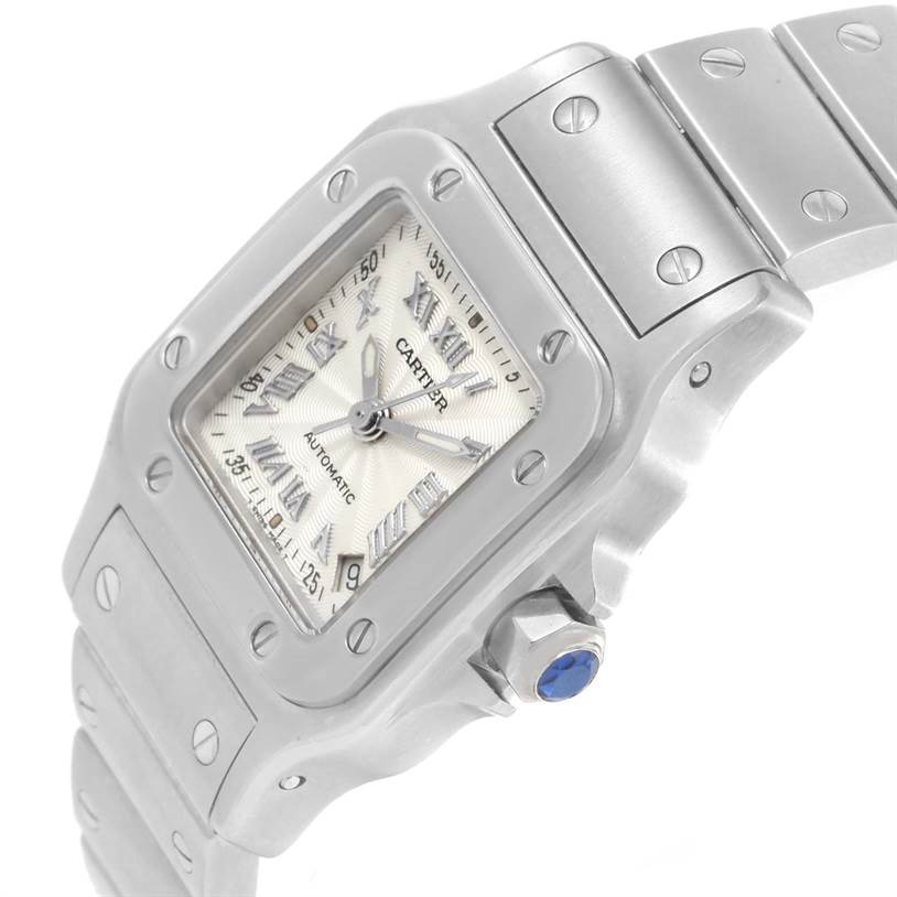 The image shows a close-up angle of the dial, bezel, crown, and part of the bracelet of a Santos model watch by Cartier.