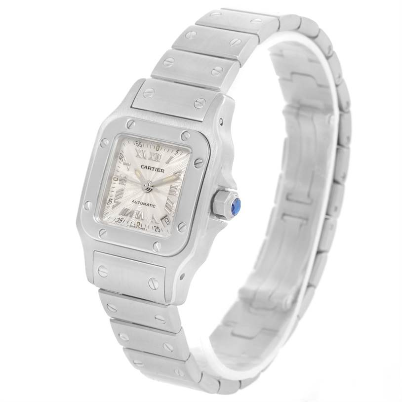 The image shows a close-up, angled view of a Santos model by Cartier, highlighting its face, bezel, crown, and bracelet.