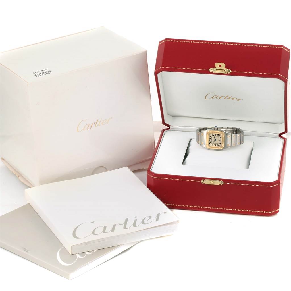 The image shows a Cartier Santos W20012C4 Women's Stainless Steel Silver Dial W20012C4 Women's Stainless Steel Silver Dial watch in its red box, along with outer packaging and booklets at a front angle.