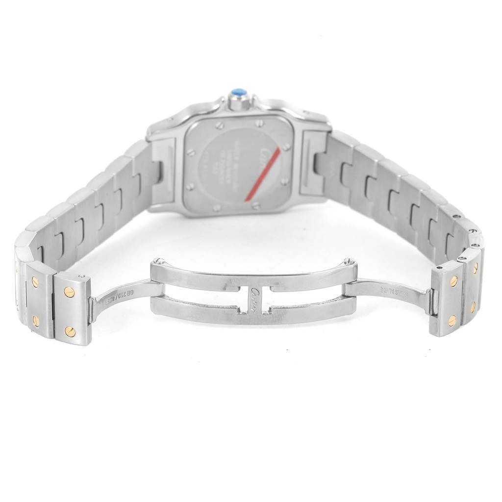 The image shows the backside and open clasp of a Santos model by Cartier, highlighting the metal bracelet and case back.