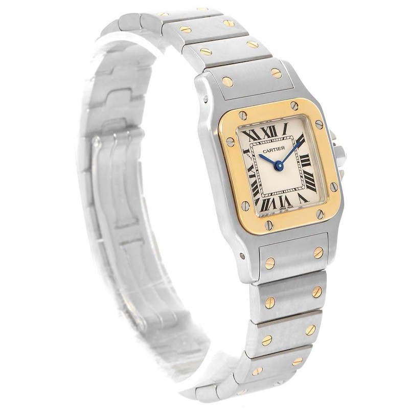 The Cartier Santos watch is shown at a three-quarter angle highlighting its dial, bezel, and part of the bracelet.