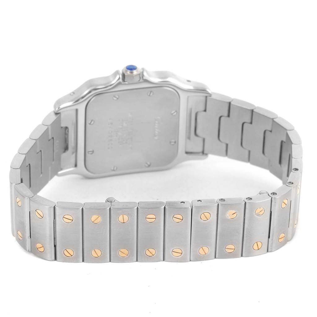 The image shows the rear view of a Cartier Santos W20011C4 Stainless Steel Silver Dial W20011C4 Stainless Steel Silver Dial watch, highlighting its case back and stainless steel bracelet with gold screws.