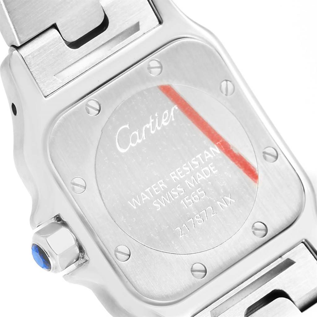 The image shows the back case and part of the bracelet clasp of a Santos watch by Cartier.