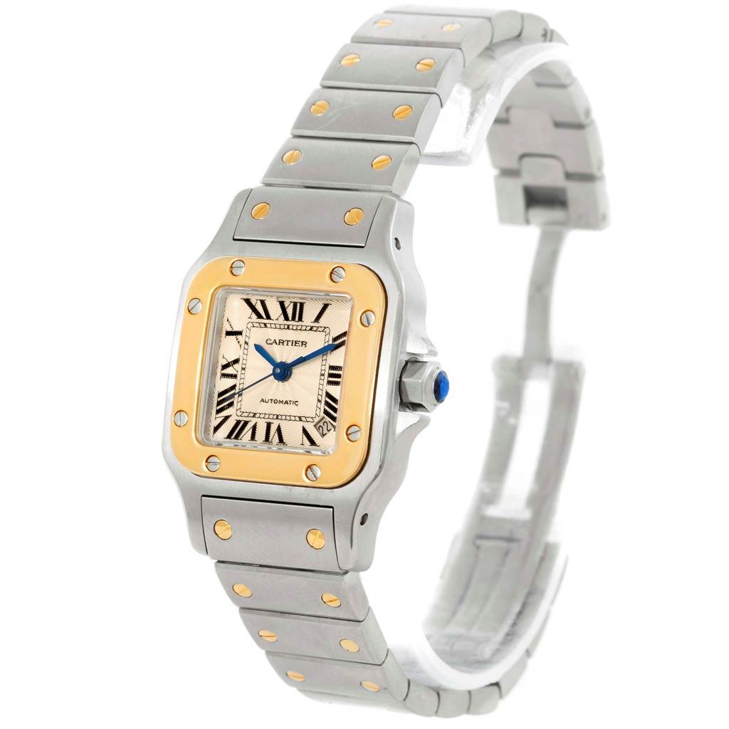 This image shows a Cartier Santos W20057C4 Women's Stainless Steel Beige Dial W20057C4 Women's Stainless Steel Beige Dial watch from an angled view, highlighting its dial, bezel, and bracelet.