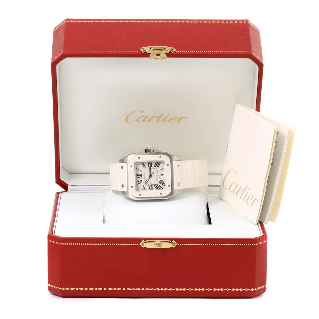 The image shows a Cartier Santos W20129U2 Women's Stainless Steel Silver Dial W20129U2 Women's Stainless Steel Silver Dial watch in its red box, positioned facing forward with a booklet to the side.
