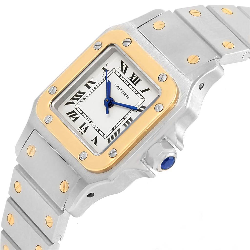 The image shows a Cartier Santos Women
s Stainless Steel Silver Dial Women
s Stainless Steel Silver Dial watch from an angled perspective, highlighting its square face, bezel, and portion of the band.
