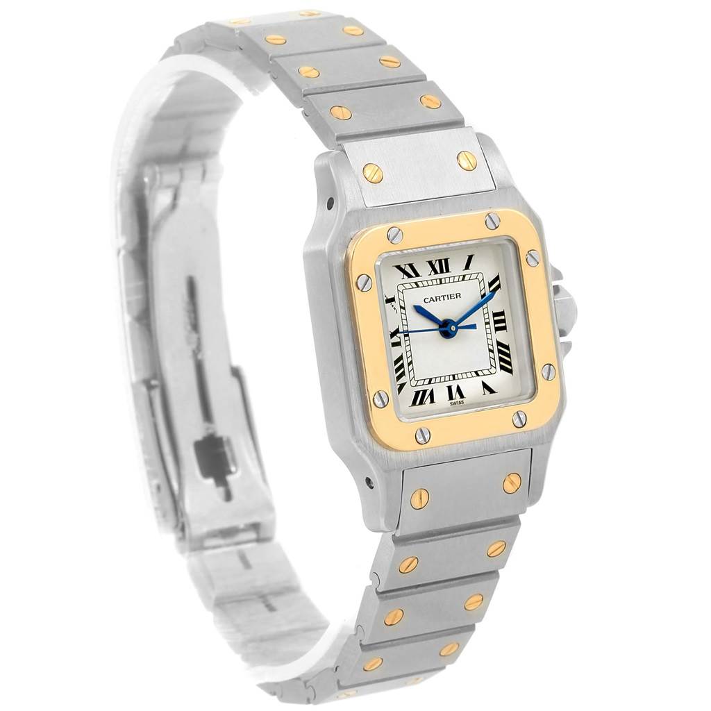 The Cartier Santos Women
s Stainless Steel Silver Dial Women
s Stainless Steel Silver Dial watch is shown at a slight angle, highlighting its rectangular face, bezel, and metal bracelet with gold screws.