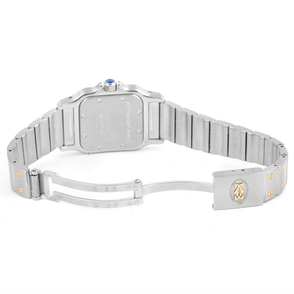 The image shows the back view of the Santos model by Cartier, focusing on the open stainless steel bracelet and clasp.