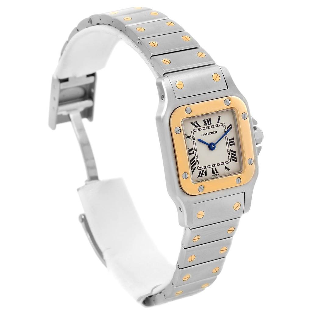 This image shows a Cartier Santos 1057930 Women
s Stainless Steel Silver Dial 1057930 Women
s Stainless Steel Silver Dial watch at a three-quarter angle, highlighting its face and silver-gold bracelet.