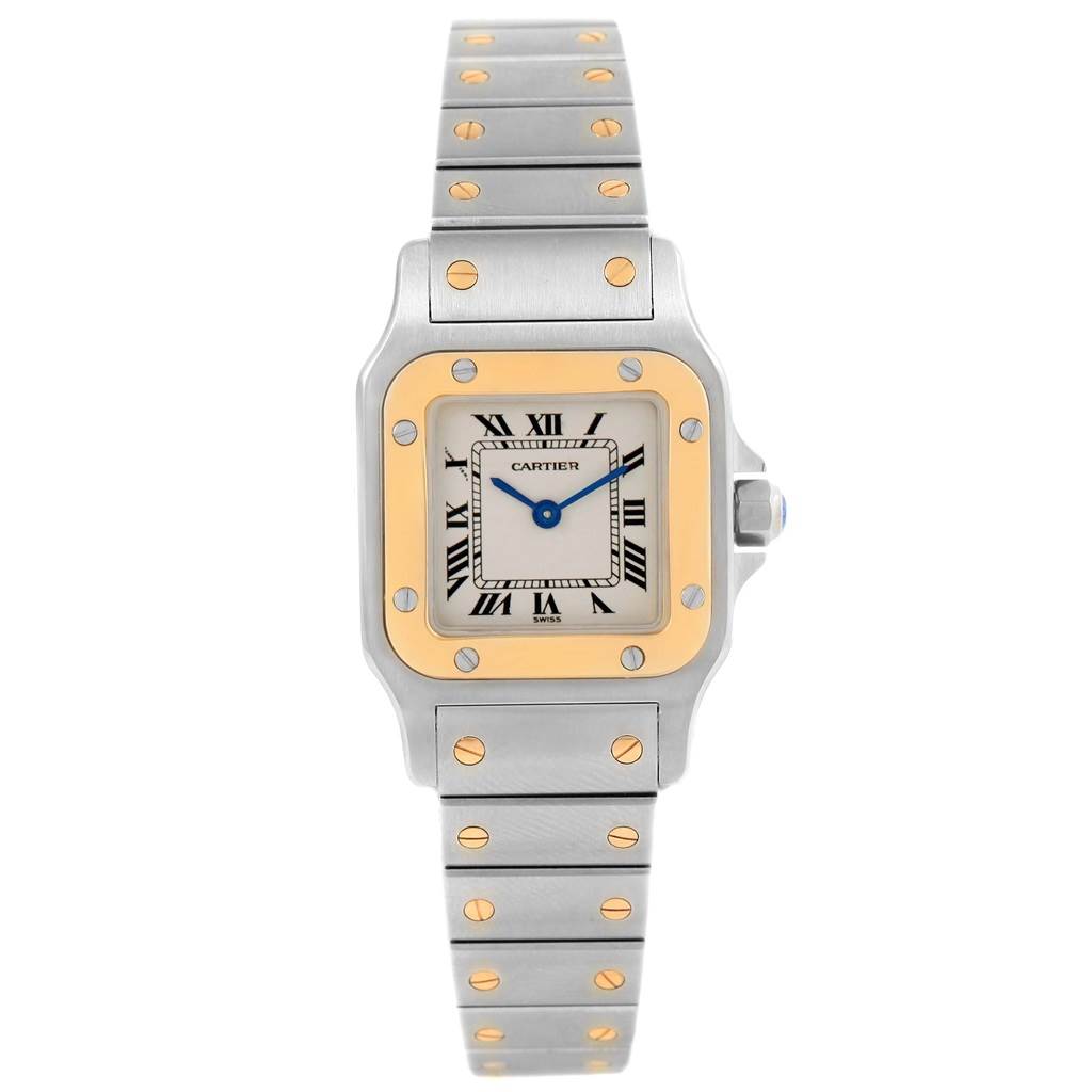 The photo shows a frontal view of a Santos model watch by Cartier, featuring the dial, bezel, and bracelet.