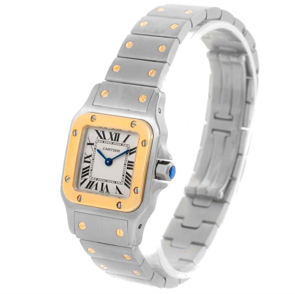This Cartier Santos W20012C4 Women
s Stainless Steel Silver Dial W20012C4 Women
s Stainless Steel Silver Dial watch is shown from a slightly angled top view, highlighting its face, bezel, and metal bracelet.