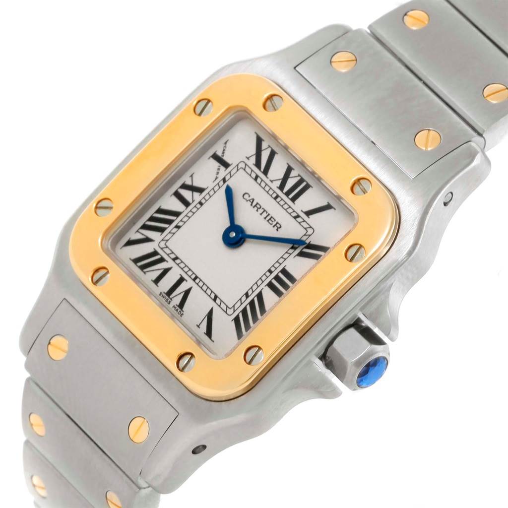 The image shows a close-up of the Cartier Santos W20012C4 Women
s Stainless Steel Silver Dial W20012C4 Women
s Stainless Steel Silver Dial watch face, bezel, and part of the bracelet at an angled view.