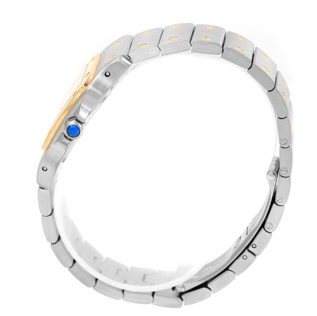 The Cartier Santos W20012C4 Women
s Stainless Steel Silver Dial W20012C4 Women
s Stainless Steel Silver Dial watch is shown from a side angle, highlighting its bracelet and crown.