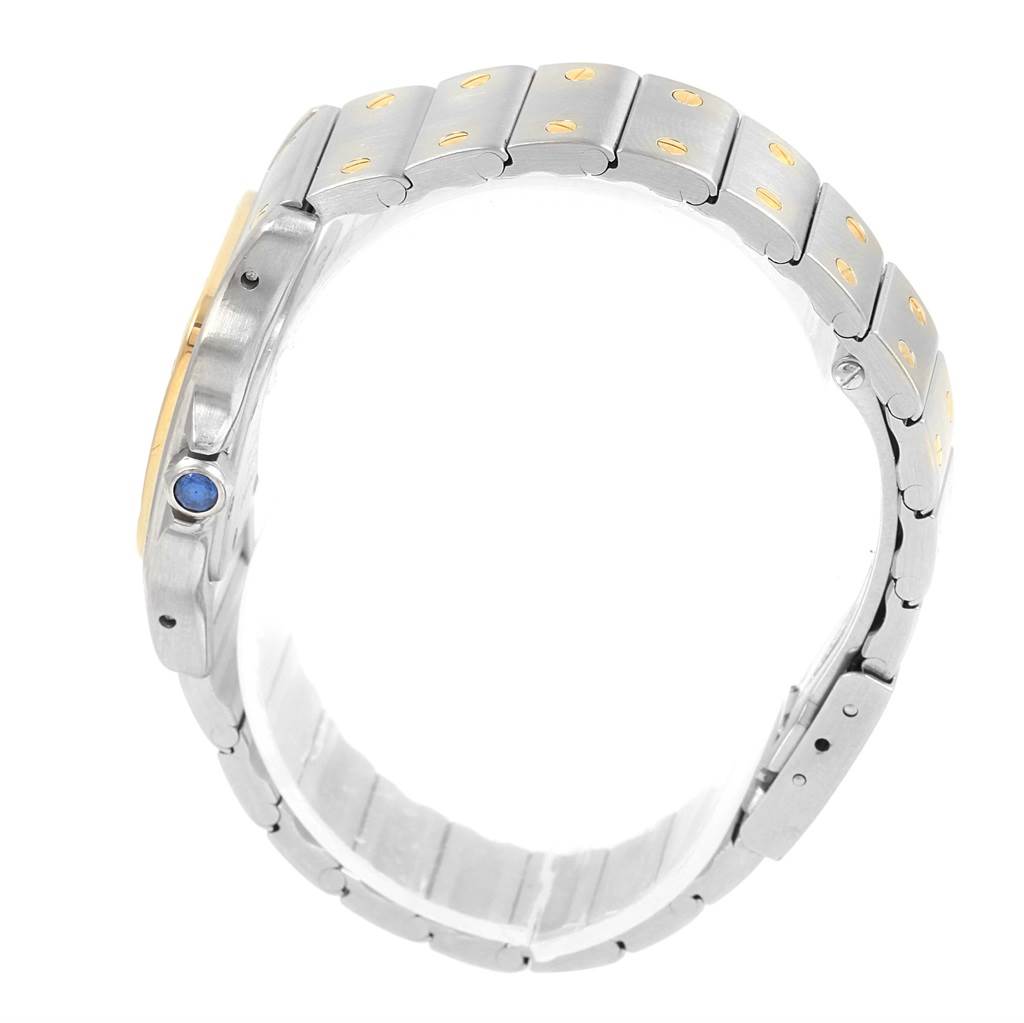 The image shows a side view of the Santos model by Cartier, highlighting the bracelet and crown with a blue cabochon.