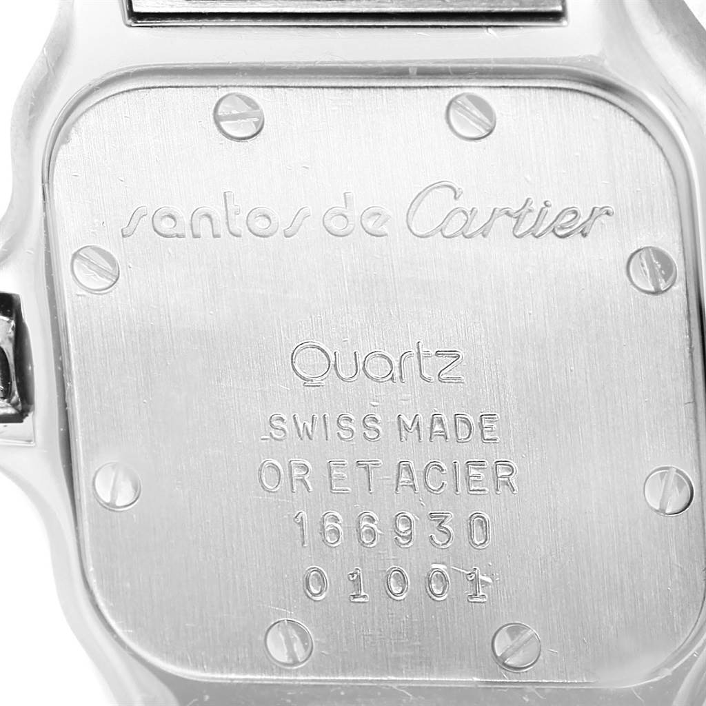 The image shows the back case of a Santos model Cartier watch, featuring engravings and screws.