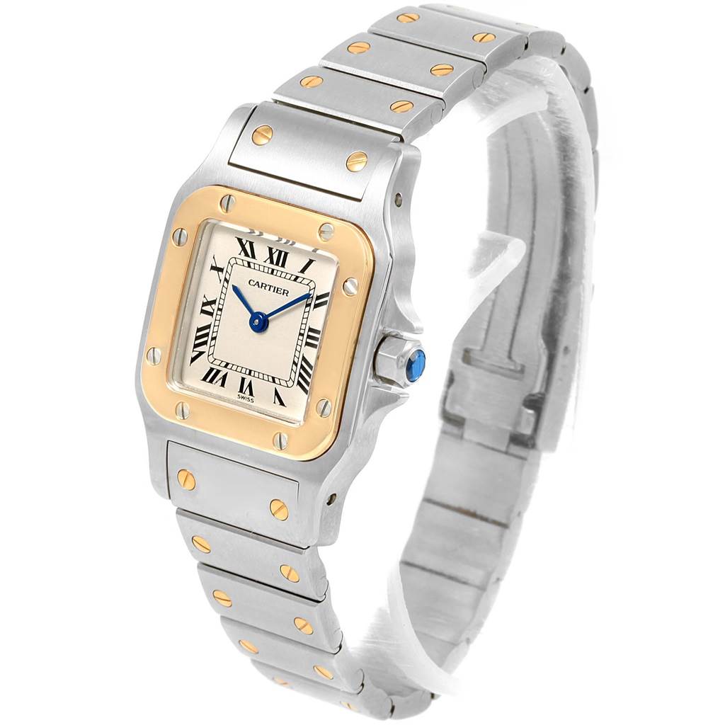 The Santos model by Cartier is shown at an angle highlighting the face, bezel, and bracelet.