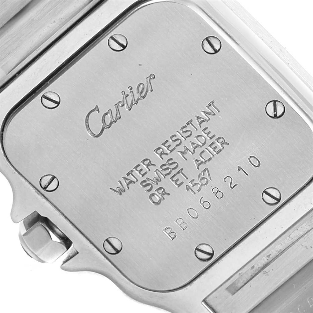 The image shows the back case of a Cartier Santos 1567 Women's Stainless Steel Silver Dial 1567 Women's Stainless Steel Silver Dial watch at an angle, highlighting its screws and engraved details.