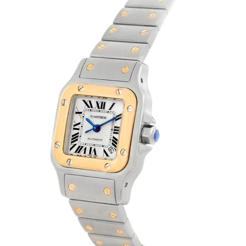 The image shows a Cartier Santos W20057C4 Women's Stainless Steel Silver Dial W20057C4 Women's Stainless Steel Silver Dial watch from a side angle, highlighting its face, bezel, bracelet, and crown.