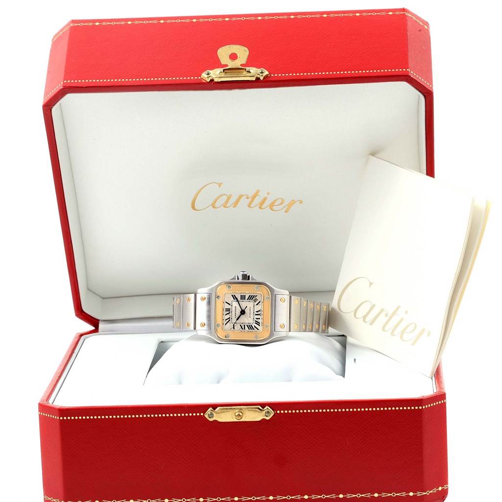 The Cartier Santos W20057C4 Women's Stainless Steel Silver Dial W20057C4 Women's Stainless Steel Silver Dial watch is displayed in an open red box with a booklet beside it.