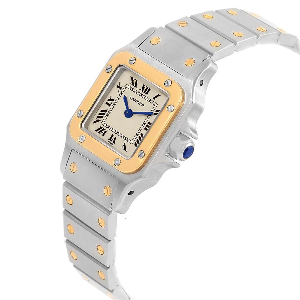 This Cartier Santos 1567 Women's Stainless Steel Silver Dial 1567 Women's Stainless Steel Silver Dial model watch is shown at an angle, highlighting the face, bezel, and bracelet with gold accents.