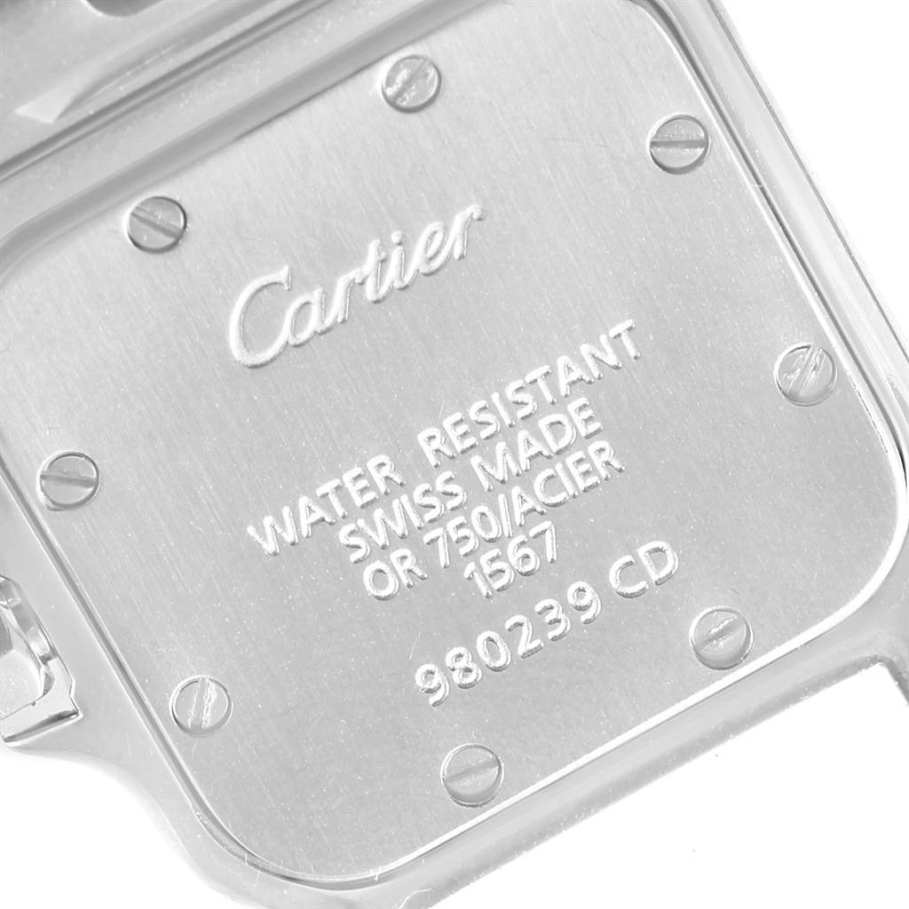 This image shows the back casing of a Santos model watch by Cartier, highlighting the engraved details and screws.