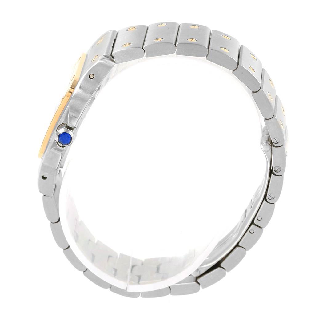 The image shows a side view of the Santos model by Cartier, focusing on its bracelet and a blue cabochon on the crown.