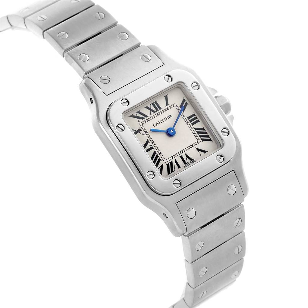 The image shows a close-up of the Cartier Santos W20056D6 Men's Stainless Steel Silver Dial W20056D6 Men's Stainless Steel Silver Dial watch face and part of the metal bracelet, viewed at an angle.
