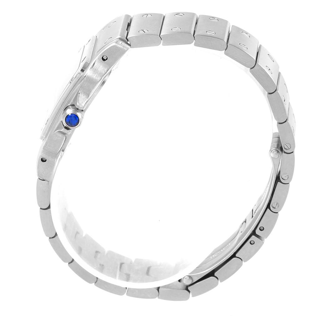 The image shows a side view of a Santos de Cartier watch, highlighting its bracelet and blue cabochon crown.