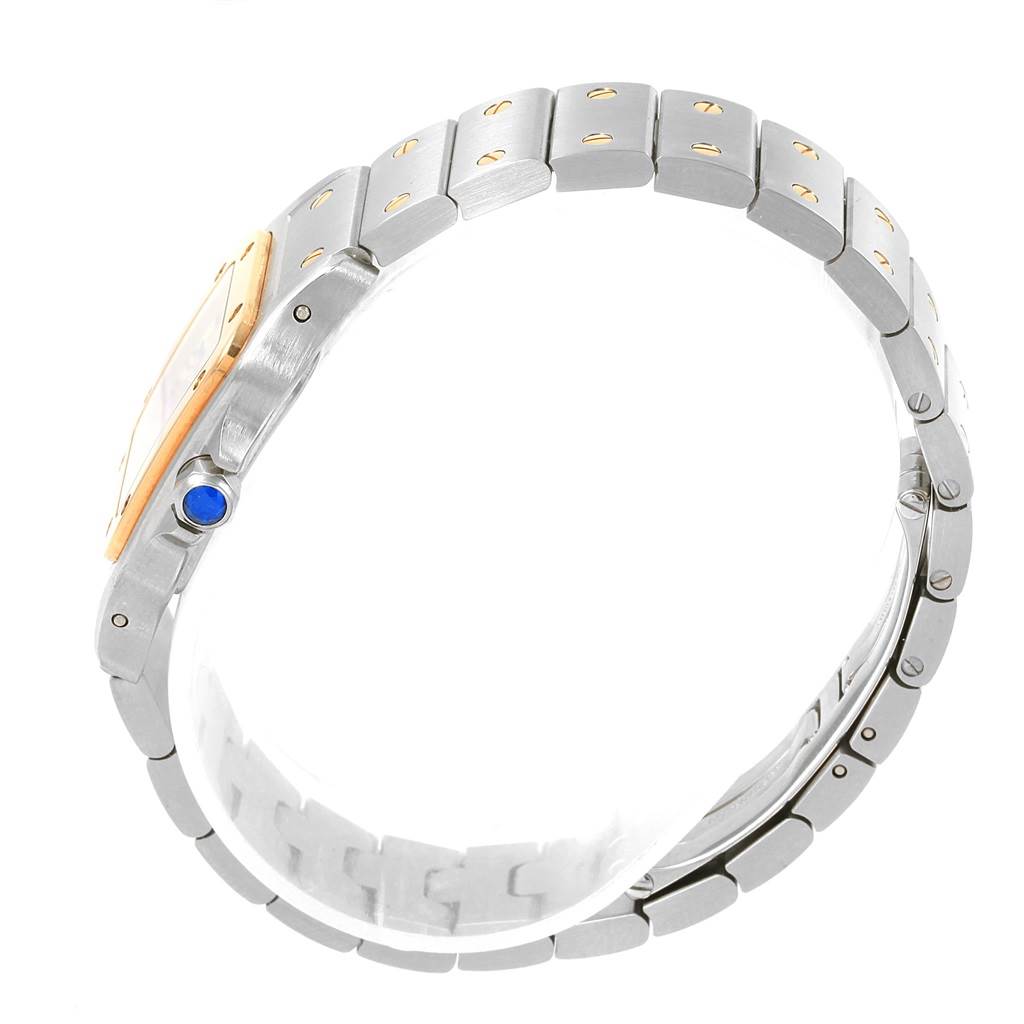 This image shows a side view of a Cartier Santos W20012C4 Women's Stainless Steel Silver Dial W20012C4 Women's Stainless Steel Silver Dial watch, detailing its metal bracelet and blue cabochon crown.