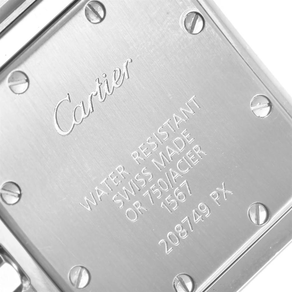 This image shows the back case of a Cartier Santos W20012C4 Women's Stainless Steel Silver Dial W20012C4 Women's Stainless Steel Silver Dial watch, highlighting its inscriptions and screws.